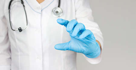 Doctor presenting and showing copy space for product or text. Medical professional handed holding...