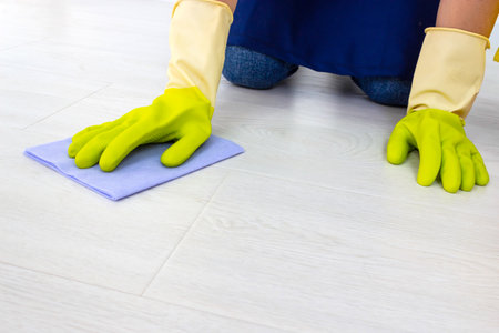 The concept of cleaning service. Cleaning floor using rag. General or regular cleanup. Commercial cleaning companyの写真素材