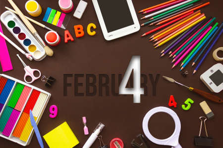 February 4th. Day 4 of month, Calendar date. School notebook and various stationery with calendar day. School and office supplies frame. Winter month, day of the year conceptの写真素材