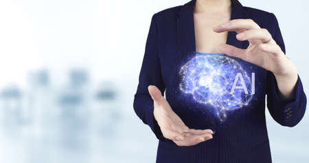 The modern concept of the cyberbrain. Two hand holding virtual holographic Brain icon with light...