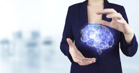 Digital Brain Artificial intelligence. Two hand holding virtual holographic Brain icon with light...