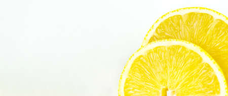 Close up of two round orange citrus slices on white background, banner orientation.の写真素材