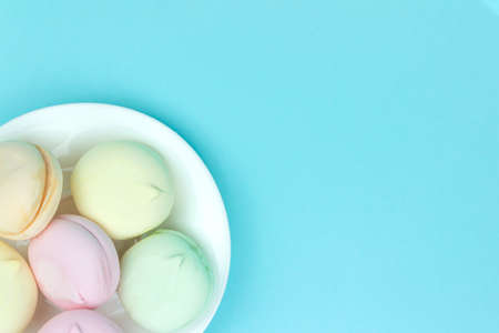 Different mini green, pink and orange puffy marshmallows looks like macaroons. A lot of handmade marshmallowの写真素材