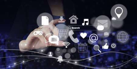 social media concept. communication network. Hand hold digital hologram social media icons sign on city dark blurred background. digital online conceptの写真素材