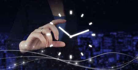 Time Management Duration Interval Graphic Concept. Hand hold digital hologram clock sign on city dark blurred backgroundの写真素材