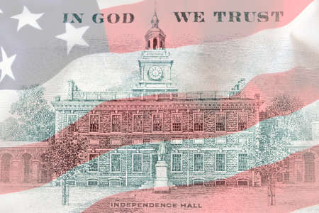 US 100 dollar bill back side close up on american flag background. Hundred dollars bill Independence...