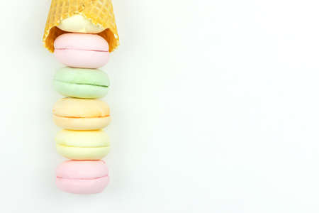 Sweet, bright marshmallow looks like macaroons in the form of an ice cream in a waffle cup turn up. top view. Free space for textの写真素材