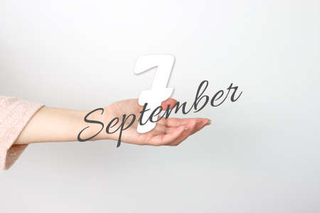 September 7th. Day 7 of month, Calendar date. Calendar Date floating over female hand on gray background. Autumn month, day of the year conceptの写真素材