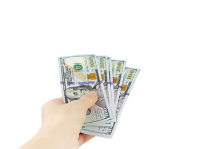 Close-Up Of Hand Holding Paper Currency Against White Background.