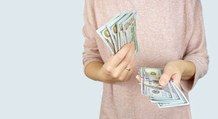 American dollars or US dollars: hand counting one hundred American money or 100 USD