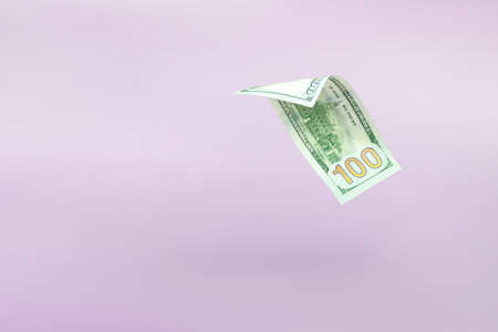 Flying one hundred dollars bills on pastel background. US 100 dollar bill close up. flying money.の写真素材