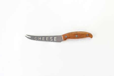 Kitchen chef knive for cheese laying on white background, flat lay, view from above, space for a...