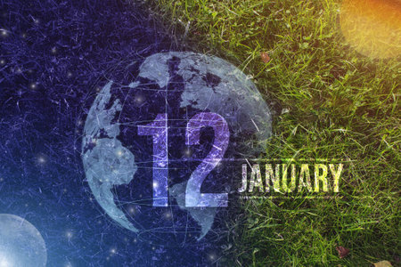 January 12nd. Day 12 of month, Calendar date. Day to night background concept. Scene with globe the green grass with sun, stars, moon and calendar date. Winter month, day of the year conceptの写真素材
