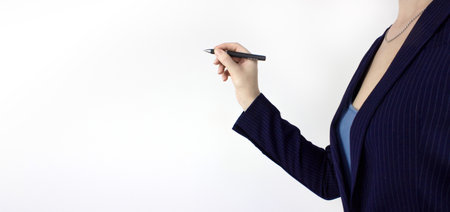 Businesswoman hold pen on virtual screen, dark background, closeup. Closeup of hand holding a black marker about to write somethingの写真素材
