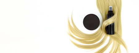 Different professional hairdresser tools hair spray with balsam hair cream and strand of blonde hair on white background, flat lay. Hair care spa concept. selfcare and wellnessの写真素材