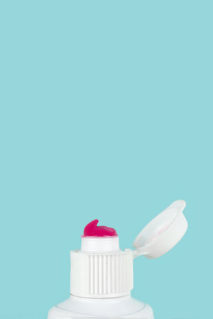 Toothpaste squeezed out from a toothpaste tube. Toothpaste dental care, Tooth paste close up on blue backgroundの写真素材
