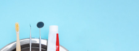 Dentist Professional tools medical equipment toothbrush, toothpaste on Blue background. Dental hygiene and health conceptual image.の写真素材