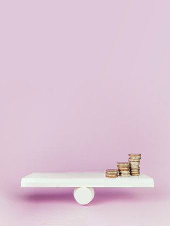 Close-up Of Balancing Stacked Of Coins Money On pink background. Balancing money