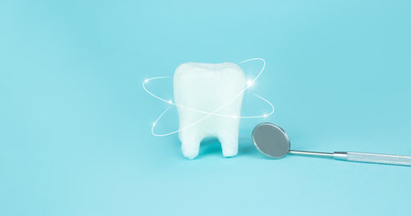Whitening of human tooth, white shining tooth and dentist mouth mirror, crystal whitening, Teeth enamel protection, Antibacterial mouth cavity care. Oral Care Concept. Dental Hygiene and Healthの写真素材