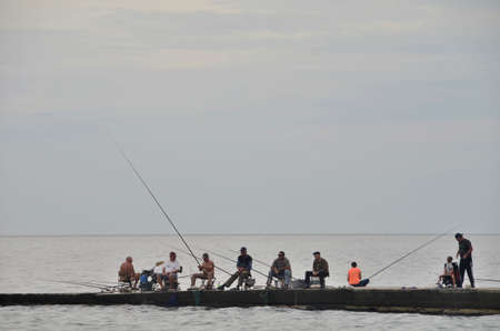 SOCHI, RUSSIA SEPTEMBER, 2014: View of fishermen on  beach in the Sochi, Russiaのeditorial素材