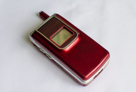 Old fashion red mobile phone on a white blackgroundの写真素材