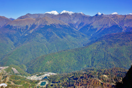 View of the sports hotel complex Rosa Plateau on the background of the Caucasus Mountains. Sochi...
