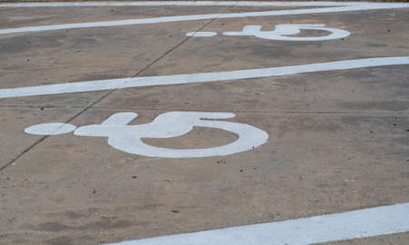 The symbol is a parking space for the disabled. Close-up of international markings for disabled...