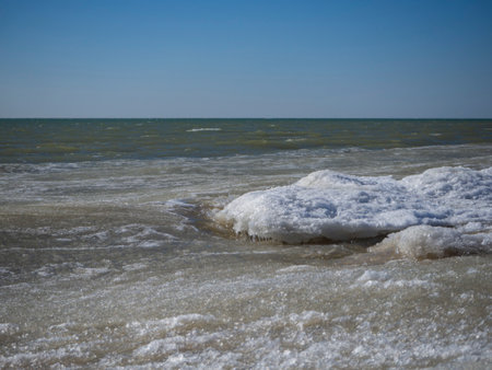 Sea waves made of snow and ice porridge. Blocks of ice and snow float in the sea and form intricate shapes. Sea water in winter.の写真素材
