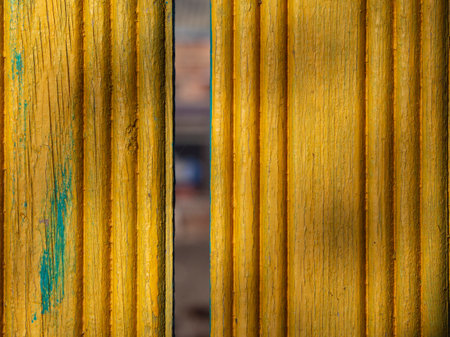 Abstract textured background of relief boards painted yellow. Old vintage boards as a background.