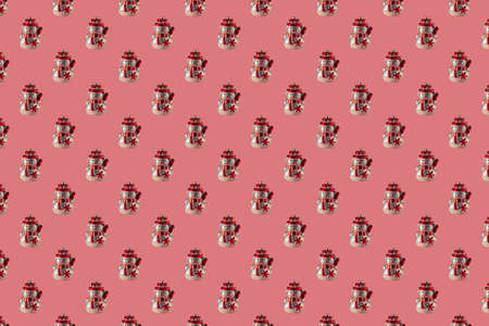 Christmas seamless pattern with snowmen on a pink surface. Winter pattern on a pastel pink background. Christmas ball snowman. Template for wallpaper, holiday packaging.の写真素材