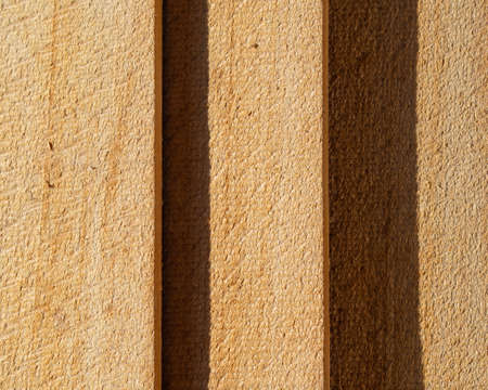 Natural background made of wooden planks. The wooden surface is made of light pine boards lying on...
