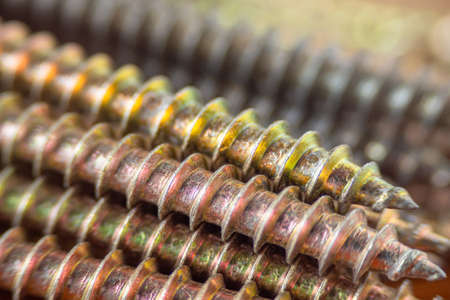 A close-up of the screws is an abstract background. A macro with a small depth of field. Focus on...