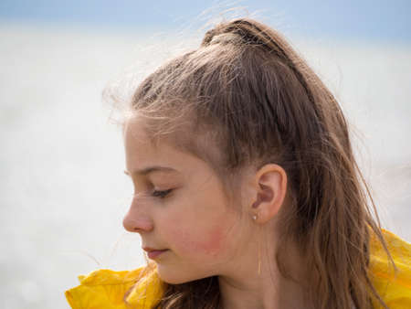 Portrait of a happy girl in close-up without retouching with her natural flaws. Portrait of a beautiful blonde teenage girl. Lifestyle freedom is a spring concept.の写真素材