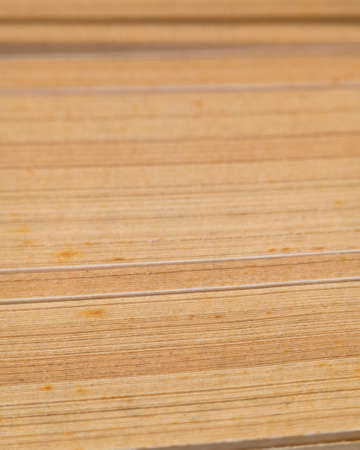 abstract paper background. Macro photo of the tips of old yellowed pages of the book, selective focus. Pages of an old yellowed book.の写真素材