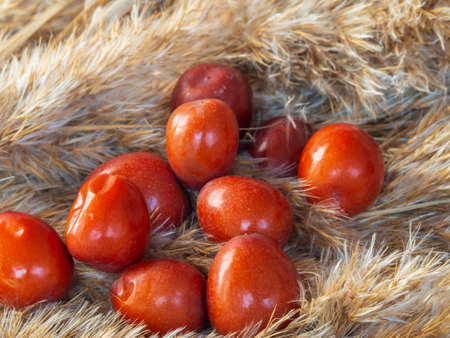 Ripe juicy unabi berries (ziziphus) close-up. Shiny orange fruit marmalade- jujubeの写真素材