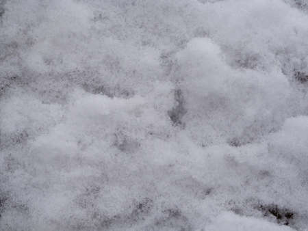 Background Texture surface of white snow. Close-up of freshly fallen snow on a sunny day. Abstract background or texture of the winter seasonの写真素材