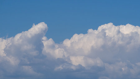 Blue sky with white clouds. Close White cumulus clouds on skyの写真素材