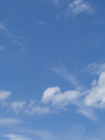 Amazing sky background for design. Blue sky and light white clouds on a sunny summer dayの写真素材