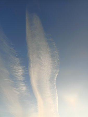 Extraordinary picturesque cirrus clouds in the blue sky. Vertical photo - background, wallpaper, postcard. Sky Replacement Materialの写真素材