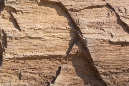 Background with a stone texture. Macro photo pattern uneven textured warm stone surface