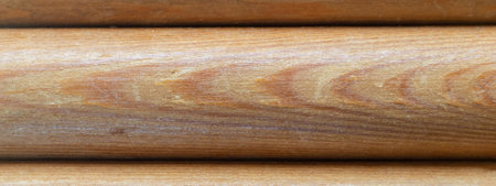 Textured background of a wooden round bar. wood texture background board of rounded logs