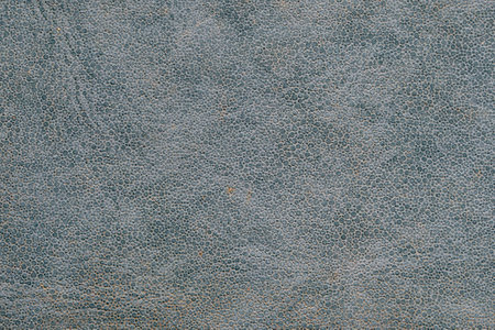Synthetic blue-gray old leather texture background. Close-up of macro of the texture of decorative materialの写真素材