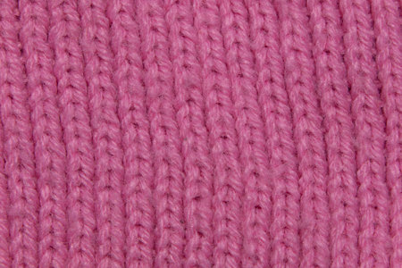 Pink background texture- macro photo of knitted wool fabricの写真素材