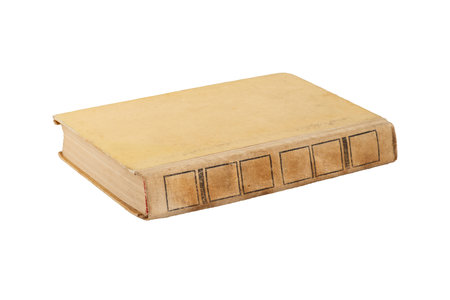 An old yellowed and battered from time closed book isolated on whiteの写真素材