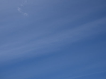 sky background. Blue sky with a white stripe of cloudsの写真素材