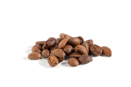 Close-up of roasted coffee beans on a white backgroundの写真素材