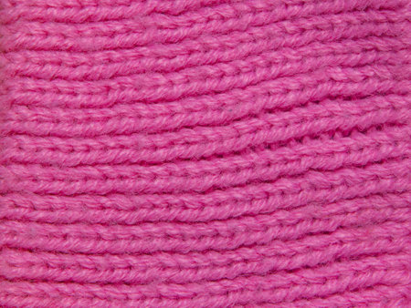 Texture of bright pink knitted wool fabric for backgroundの写真素材