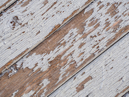 Textured background of old boards with peeling gray paint. Diagonal wooden boards close-upの写真素材
