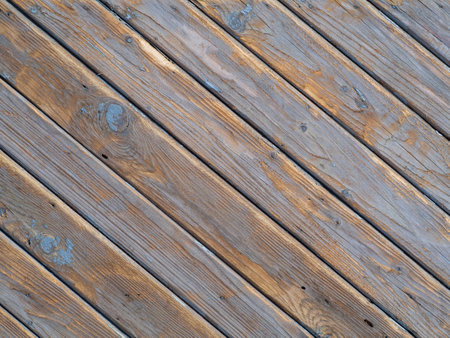 wood texture background. An old wooden wall with worn diagonal boards with natural patterns. Texture of old wood for design with free spaceの写真素材