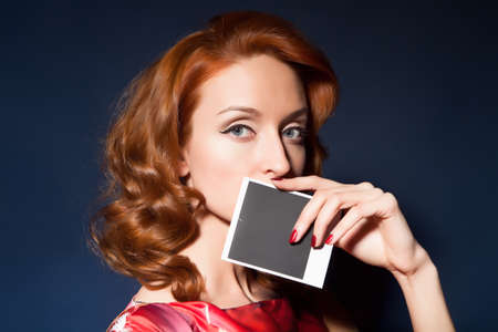 Girl with retro style camera and picture.の写真素材